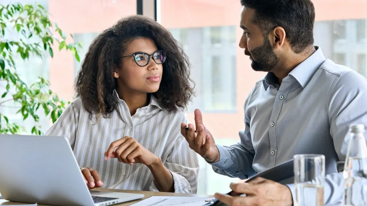 Female learner receiving one-to-one guidance from a male mentor